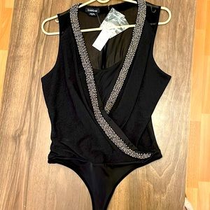 BEBE bodysuit with original tags . Size M - Black - Perfect condition.